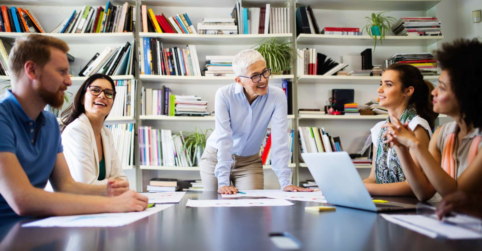 Mature woman boss leads meeting in education office