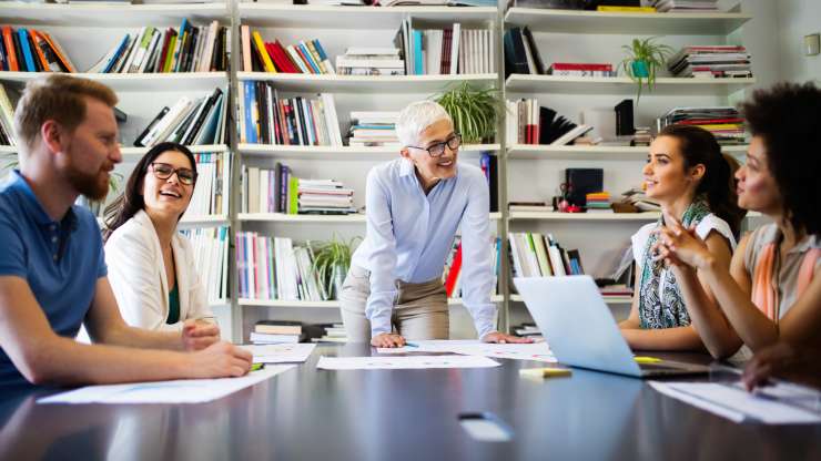 Mature woman boss leads meeting in education office