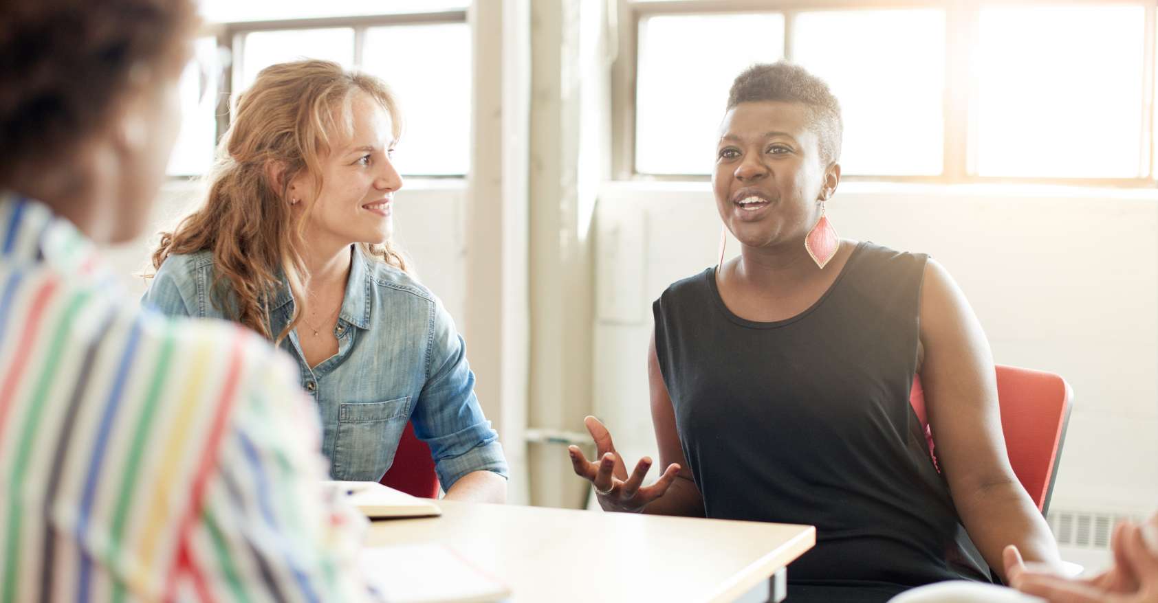 Diverse_women_discussing_meeting